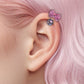 🎀✨ Ear Piercing with Pink Bow and Sparkling Crystal – Sweetness, Elegance, and Style! 💖💎